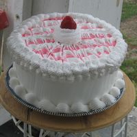 Img_0604.jpg Double Layer Yellow cake filled with strawberry satin whip...Iced with regular satin whip and strawberry satin whip and topped with a...