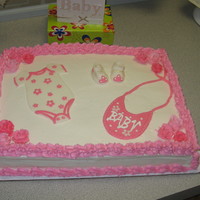Baby Shower 1/2 sheet (half white half chocolate) cake iced in butter cream with fondant accesories. This cake was inspired by another cc.