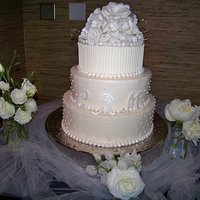 Wedding Cake I made this for my son's wedding. Buttercream with fondant pearls dusted and gumpast flowers.