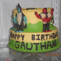 Ben 10 Cake Vanilla cake with buttercream frosting. Ben 10 is FBCT. Four arms and XLR8 are candy clay. Based off a cake by Patty T found on CC.