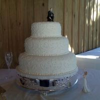 Resized_Lauren.jpg Wedding cake done with fondant icing and royal scroll work. tfl.