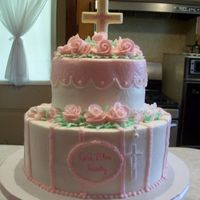 Resize_Comunion.jpg 6 and 10 inch rounds with buttercream icing, roses and white chocolate cross.