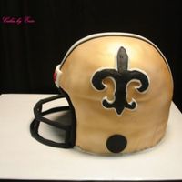 Saints Football helmet for a groom. This one was fun. I used a 9 inch round with wilton soccer ball pan on top. covered in fondant and airbrushed...