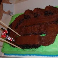 Motorcross Birthday Cake This was for my 12 year old cousin's birthday. He is a serious dirtbike racer. The cake is iced with a snow white buttercream frosting...