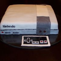 Original Nintendo This cake was for the groom at their bridal shower. It is a butter cake with chocolate frosting, covered in fondant. The lettering is hand...