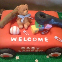 Red Wagon Cake Made this for a baby shower. It is a butter cake with homemade buttercream icing, covered in fondant. The handle, wheels, and baseball/bat...