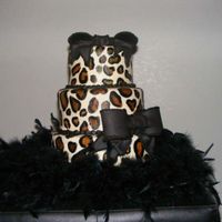 Lovely Leopard This was a for an untraditional bride.......I loved that. Just painted on leopard spots on fondant with black boa trim. TFL.