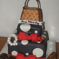Gucci Purse And Shoe This was a RKT Gucci Purse with a Gucci shoe plus accessories on top of a black and white polka dot cake. The cake also came with 3 dozen...