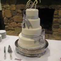 Crystal's Wedding Cake This was a four tier cake with simple silver bows and the custom topper. I love the simplicity of it. Thanks for looking.