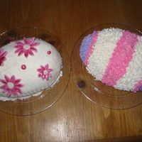 Giant Easter Eggs These were both baked in the Wilton 3-D egg pan. Frosted with buttercream. The flowers are made from MMF.