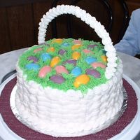 Easter Basket Basic white cake with buttercream icing.Added molded confectionary coating eggs and royal icing handle.