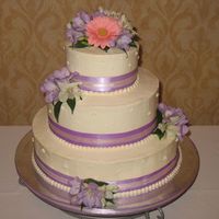 My First Wedding Cake Yeah! I am so excited. This is my first wedding cake. Yellow cake with chocolate buttercream filling and fresh flowers. A lot of work but a...