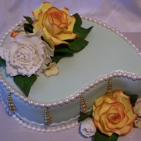 Birthday Cake Chocolate cake with Godiva Liqueur Chocolate Buttercream. The cake is covered in a mint green fondant. Roses, peony, leaves and hyrdrangeas...