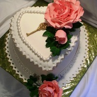 Anniversary Cake WASC with vanilla buttercream. Roses, ivy and key are gumpaste. Cake is covered in fondant and decorated with fondant pearls and lace. I...