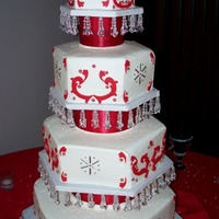 Friends Wedding Butter cake with vanilla buttercream. Decorated with fondant red scrolls and silver dragee accents.