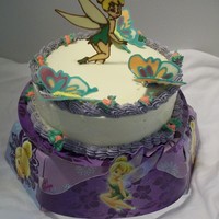 Tinkerbell Tinkerbell cake made for the school fundraiser. Liquid Chocolate Transfer of Tinkerbell. White chocolate butter cream with blueberry cake...