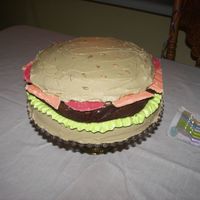 The Burger this was done for my son's 9th birthday, he wanted a hamburger cake. The cheese and tomato are white chocolate and the burger is a...