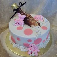 Happy New Year! Buttercream, fondant accents. Chocolate mold bottle, royal icing piped elephants.