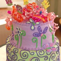 Bella's Cake A fun two-tiered cake for a 6-year old's birthday. Buttercream & fondant with inedible accents on the top.