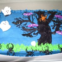 Halloween Cake My son helped do this cake. I baked it, and he decorated it for the most part. I did borders. He freehanded the tree. The bats, skulls, and...