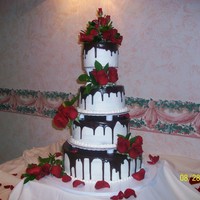 Wedding Cake The cake was traditional white cake with white buttercream -topped by untraditional chocolate ganache. Roses were real.