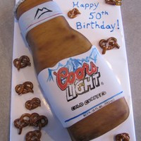 Coors Lite & Pretzels Thanks to all on CC for the inspiration.. Cake is chocolate with choc BC covered in MMF. Label is hand painted on MMF. Pretzels are MMF as...