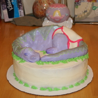 Dinosaur Baby Shower Cake Dinosaur made from rice krispies moulded into shape and covered in fondant. Cake covered in buttercream frosting.