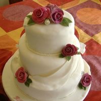Roses And Drapes This is my first wedding cake - fruit cake, chocolate biscuit cake and chocolate sponge. All fondant decorations.