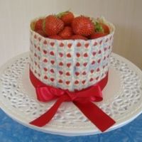 Strawberries And Roses White chocolate cake with buttercream filling and chocolate surround, covered with a heart edible transfer.