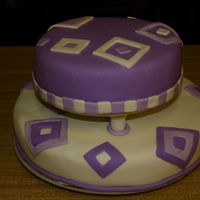 Squares This is a choc. cake with MMF for both accents and frosting, with buttercream under, this was also my first tierd cake. Not sure really how...