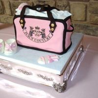 Juicy Couture Diaper Bag Baby Shower Cake Juicy Couture Diaper Bag Baby Shower Cake, all fondant with White & pink chocolate booties and rattles.