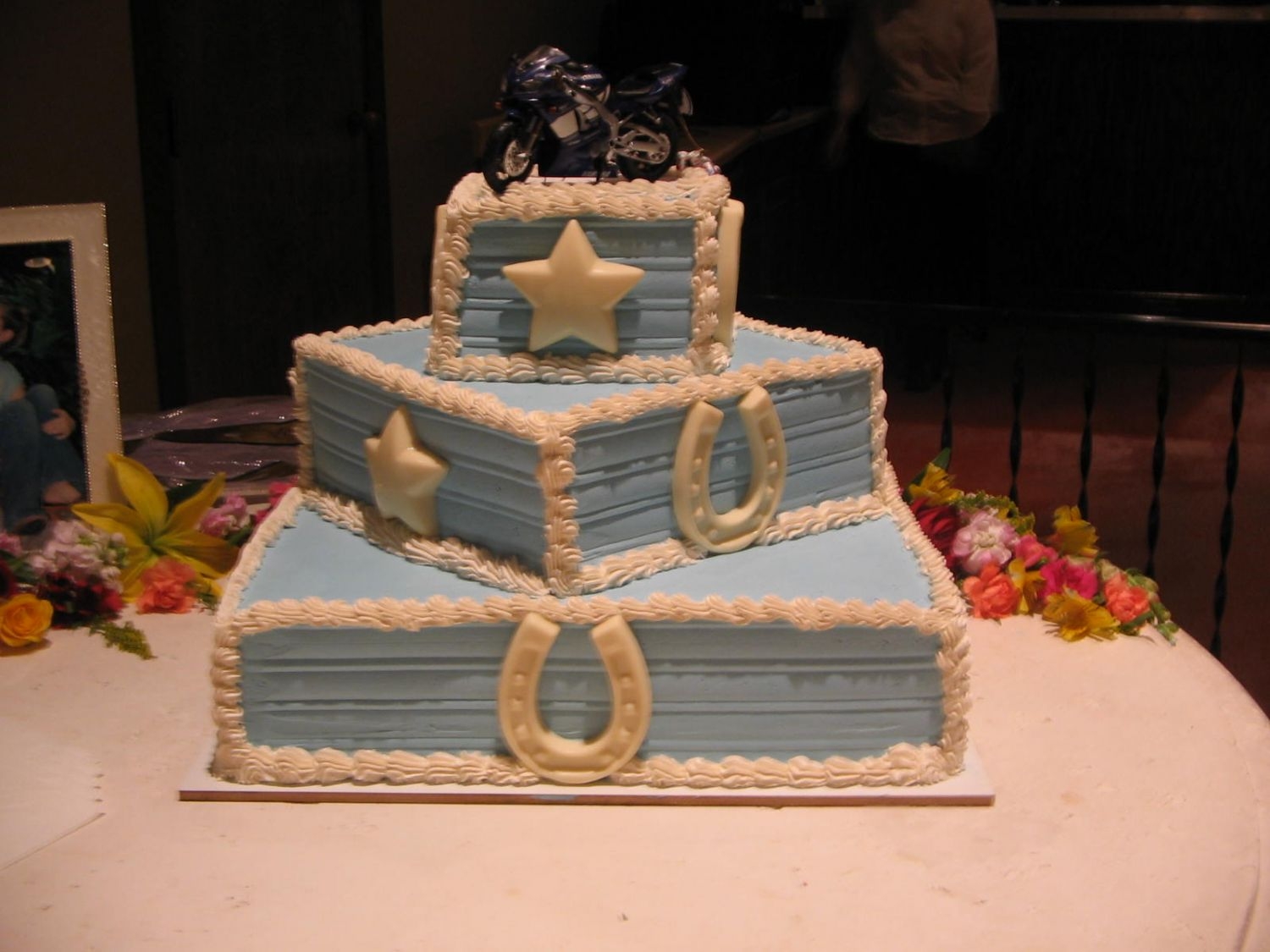 Img_0240.jpg western wedding cakewhite almond cake, whipped cream icing, stars and horseshoes made out of white choc.