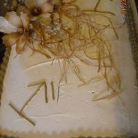 Ballard Cake 1/2 sheet Anniversary cake with the couples cattle brand on it with silk flowers, iced with buttercream icing