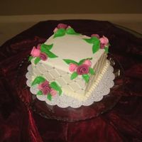 Roses And Pearls 6" square, chocolate cake with vanilla BC filling and icing. Fondant leaves and Duff roses.