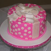 Polka Dots And Bow 8" Chocolate cake with raspberry filling, buttercream icing. Fondant details. Gumpaste bow