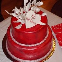 50 And Fabuluos 8" &10" stacked. This was a gluten free carrot cake with cream cheese filling and toasted coconut wrapped in red fondant with...