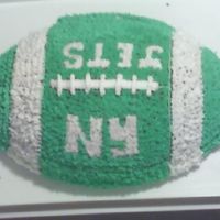 Football Cake Chocolate Cake with Buttercream Frosting. Just wanted to experimenta little. My husband chose the colors and did the letters :)