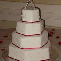 Snowflake Wedding Offset hexagons, fondant covered with red satin ribbon, fondant snowflakes made using new scrapbook punches and brushed with pearl dust....
