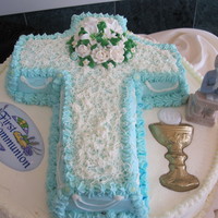 Lilly Cross Cake A cake for my cousin's communion. From an old Wilton book. The Lillies were royal icing and I didn't leave enough drying time so...