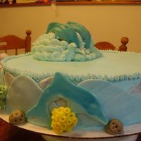 P8030744.jpg This is a dolphin cake for a 10 year old girl who is a fanatic of dolphins. It is a two layer 16 inch cake top is white chocolate filling...