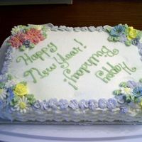 Birthday/new Year Cake Lemon cake with vanilla buttercream frosting, royal icing flowers. Created for a New Year celebration plus two family birthdays.