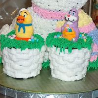 Easter Basket Jumbo Cupcakes Chocolate fudge jumbo cupcakes with buttercream frosting, marshmallow animals on top, and small candy "eggs".