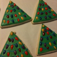 Christmas Trees So Easy! Just used a triangle cookie cutter, flooded the cookie and the lights are actually chocolate-covered sunflower seeds! These were...