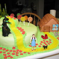 Wizard Of Oz Cake Yellow cake with buttercream filling, marshmallow fondant. Gumdrop lollypops! The rainbow is actually inside the house...it's a...