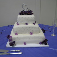 Flowers And Pearls White cake with strawberry filling, and cream cheese frosting. Wilton "pearls" on the sides and mesh ribbon with fake flowers...