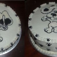 Black & White Puppy Black and White puppy with paw prints in border and sides of cake. 3 layer 12 inch chocolate cake with raspberry filling. Done with...
