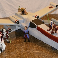 Star Wars Ship Replica of Star Wars fighter ship, was about 40 inches long and wide. My husband made the frame and I used styrofoam and cake to fill in...