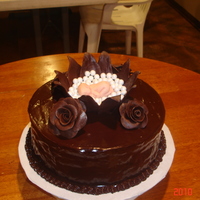 Kelly's Baby Shower Cake Chocolate cake with whipped Ganache filling covered in poured ganache. This is my first attempt at a gumpaste baby as well as chocolate...