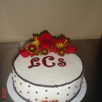 Bridal Shower Cake Chocolate cake with chocolate ganache filling covered in buttercream. Fondant monogram with fresh flowers.