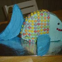 Fish Cake I made this by cutting up two 9 inch round cakes. The decorations are Skittles. It looked great, but the whole story is that it collapsed...